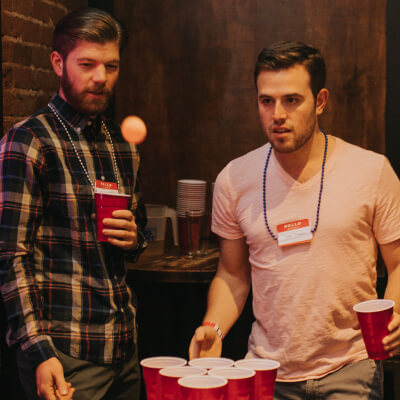 men playing beer pong
